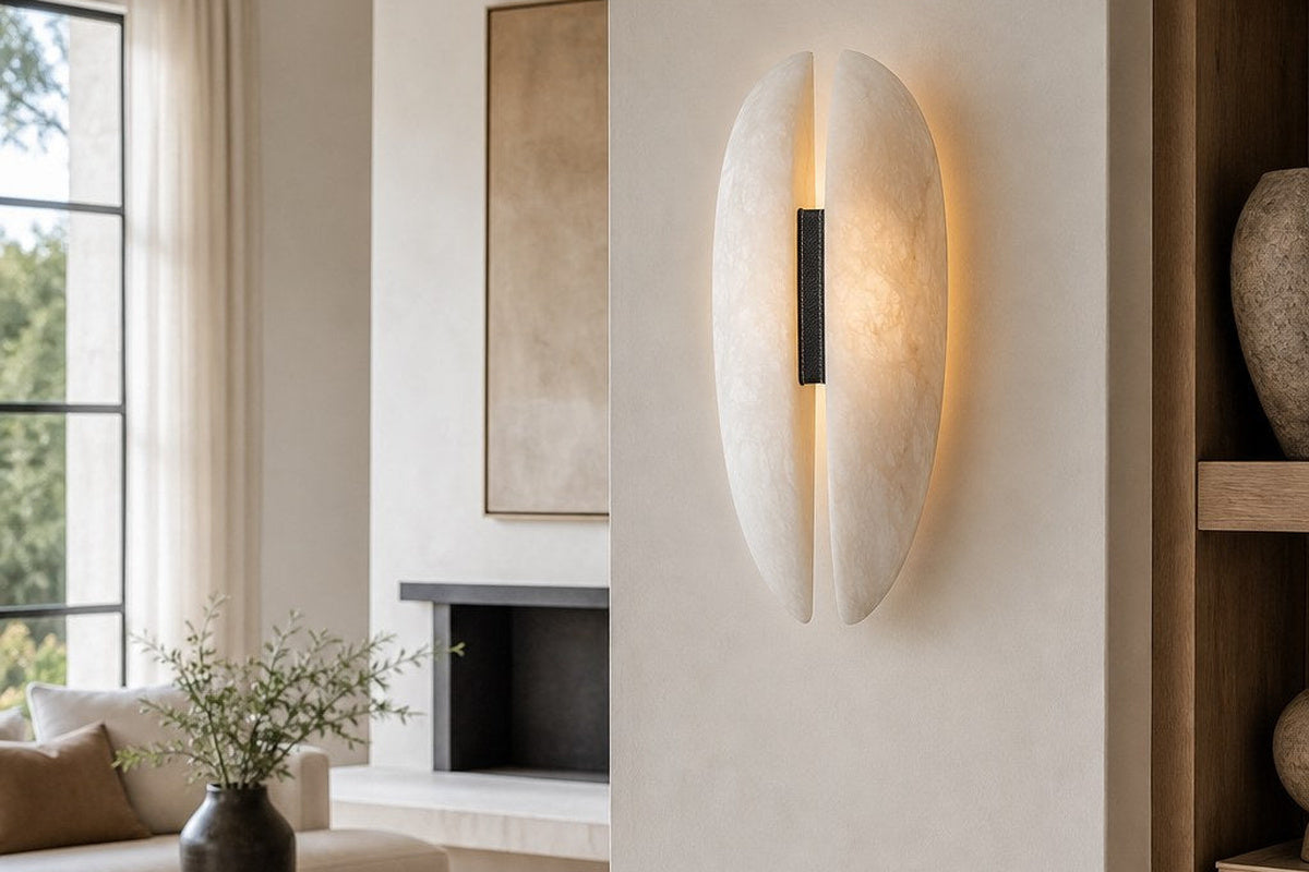 Alabaster and black leather wall sconce adding warm contrast to a neutral living room.
