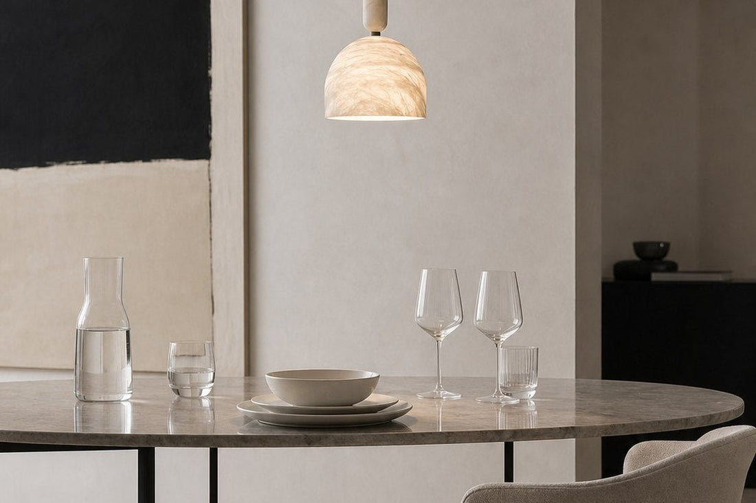 The Blair Alabaster Dome Pendant illuminating an architectural dining space with warm 3000K ambient illumination.