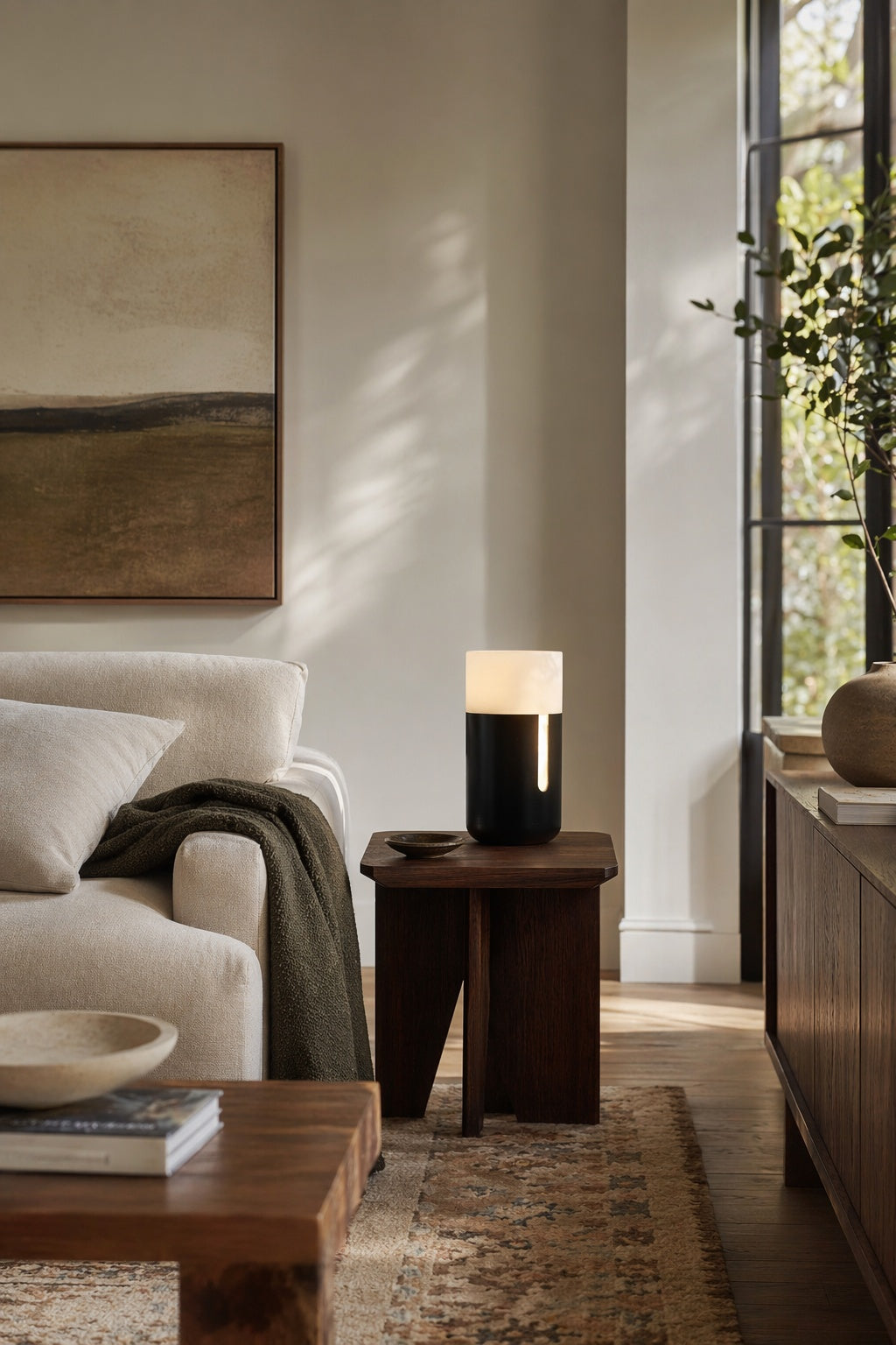 Modern Alabaster Jules Table Lamp in Matte Black placed on a living room timber side table