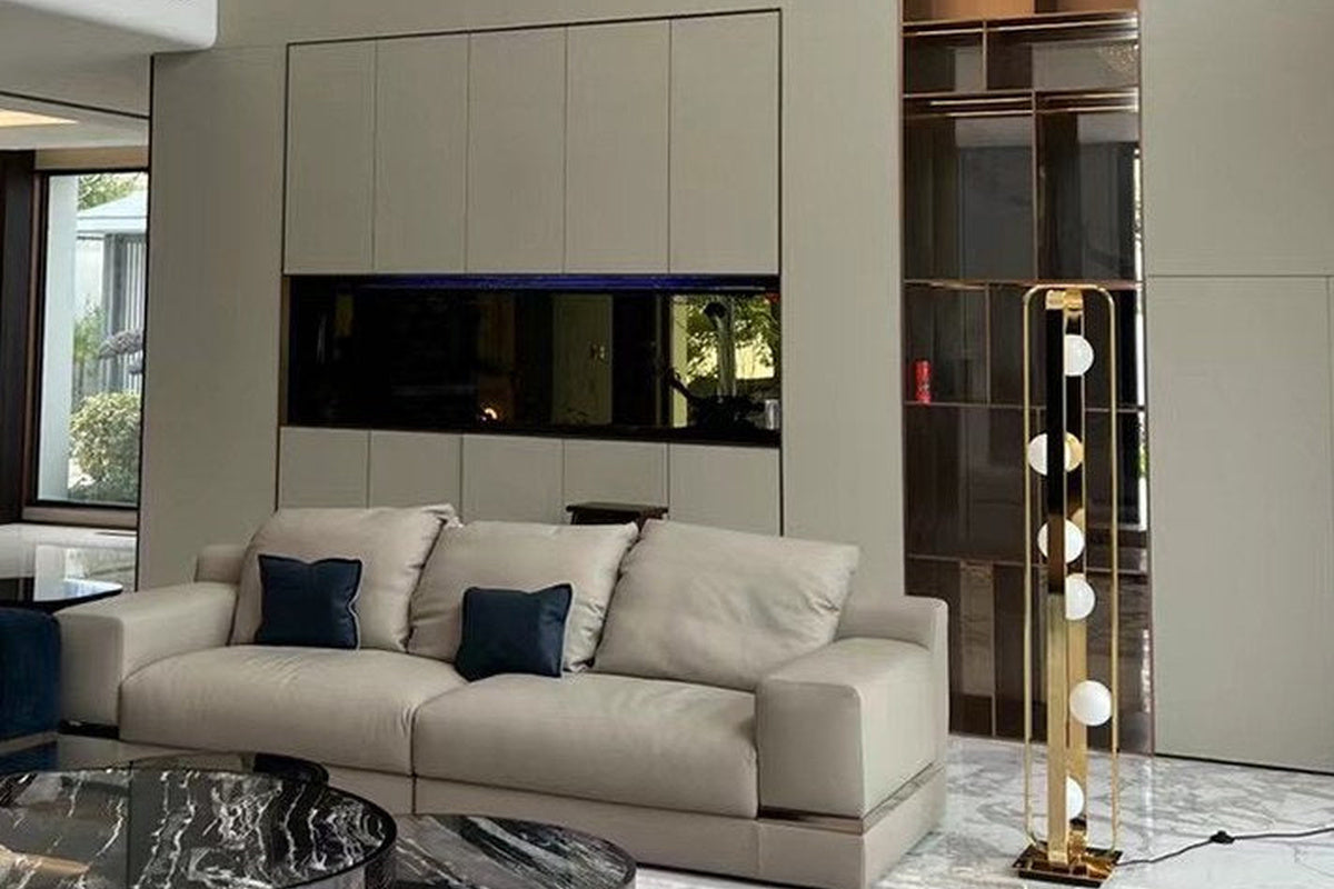 Exact Champagne Gold globe floor lamp in a study-style room scene; the image is illustrative and does not prove room scale, cord length, light output, or outlet suitability.
