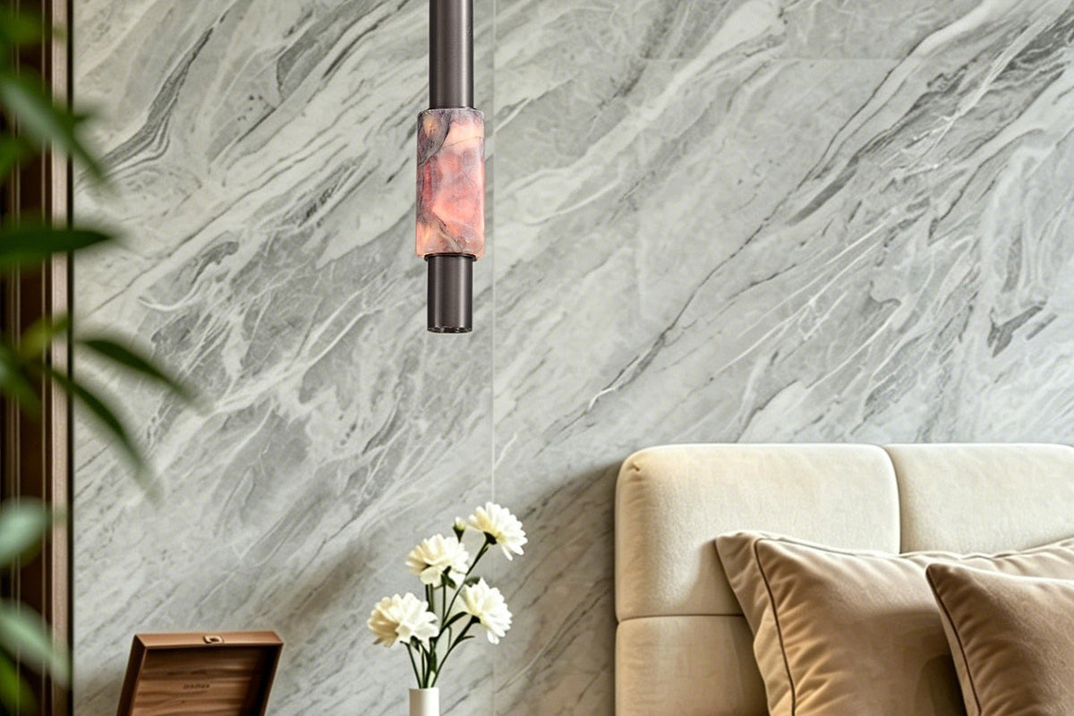 Current Shopify room image showing one dark-finish crystal cylinder pendant above a bedside table; style context only, not scale or output proof.