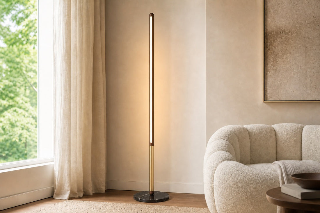 Modern Walnut LED Floor Lamp with Marble Base shown at full height beside a cream reading chair, with the lamp as the dominant visual focus.