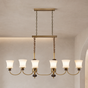 Caldrienne six-light linear chandelier product hero on a warm greige background