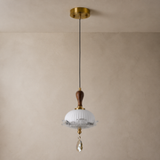 Valloren Ribbed Glass and Walnut Pendant Light on a warm neutral wall-top background