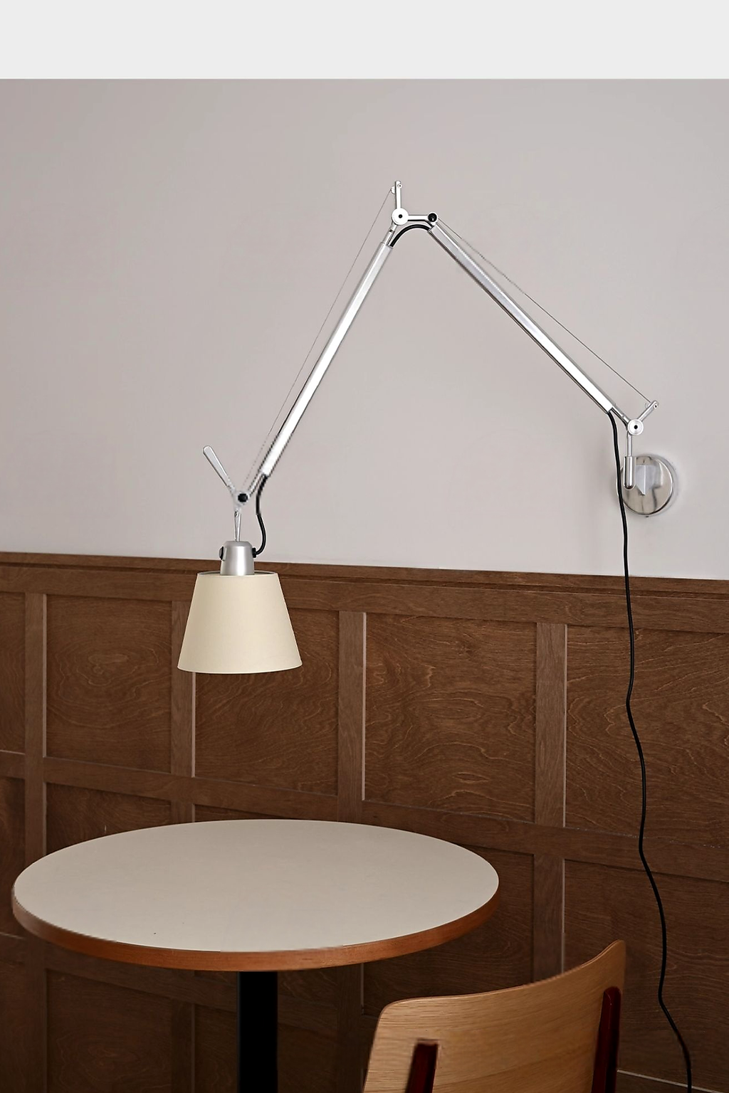 Bauhaus Adjustable Parchment Swing Arm Wall Light in a cafe wall setting