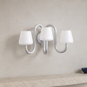 Apollo gray aluminum and opal glass three-light wall sconce mounted flush to a solid plaster wall