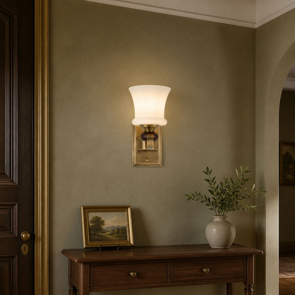 Brontelle one-light wall sconce centered above a walnut entry console