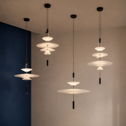 Four layered acrylic disc LED pendants arranged at varied heights with complete ceiling canopies