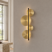 Brass Disc LED Wall Sconce product view on a warm neutral background