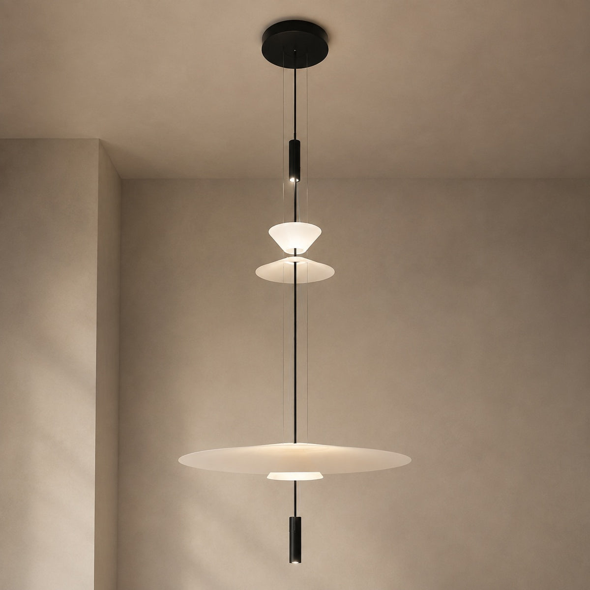 Layered acrylic disc LED pendant with complete black canopy and four-tier silhouette in a minimal interior