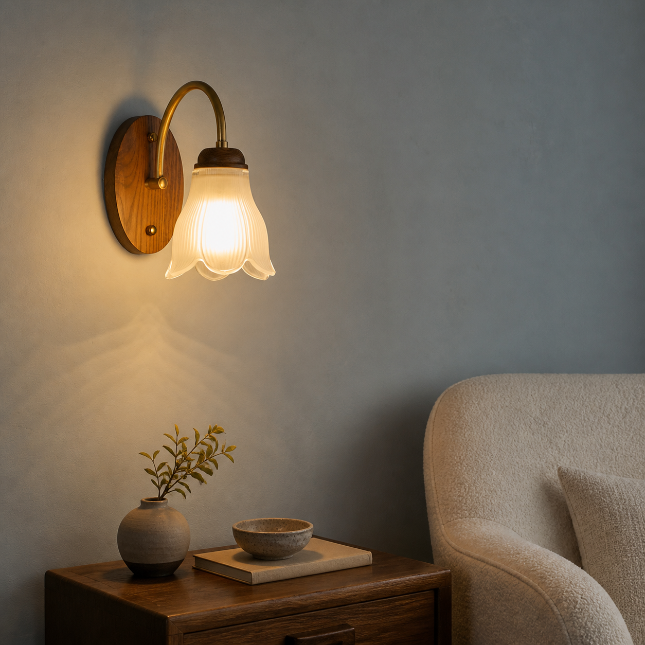Ribbed bell glass and walnut wall sconce on the left in a mineral-blue reading corner