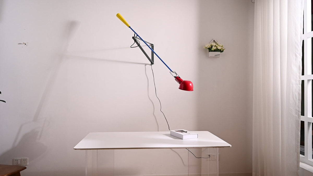 Red swing-arm wall lamp 7014 real desk view by day