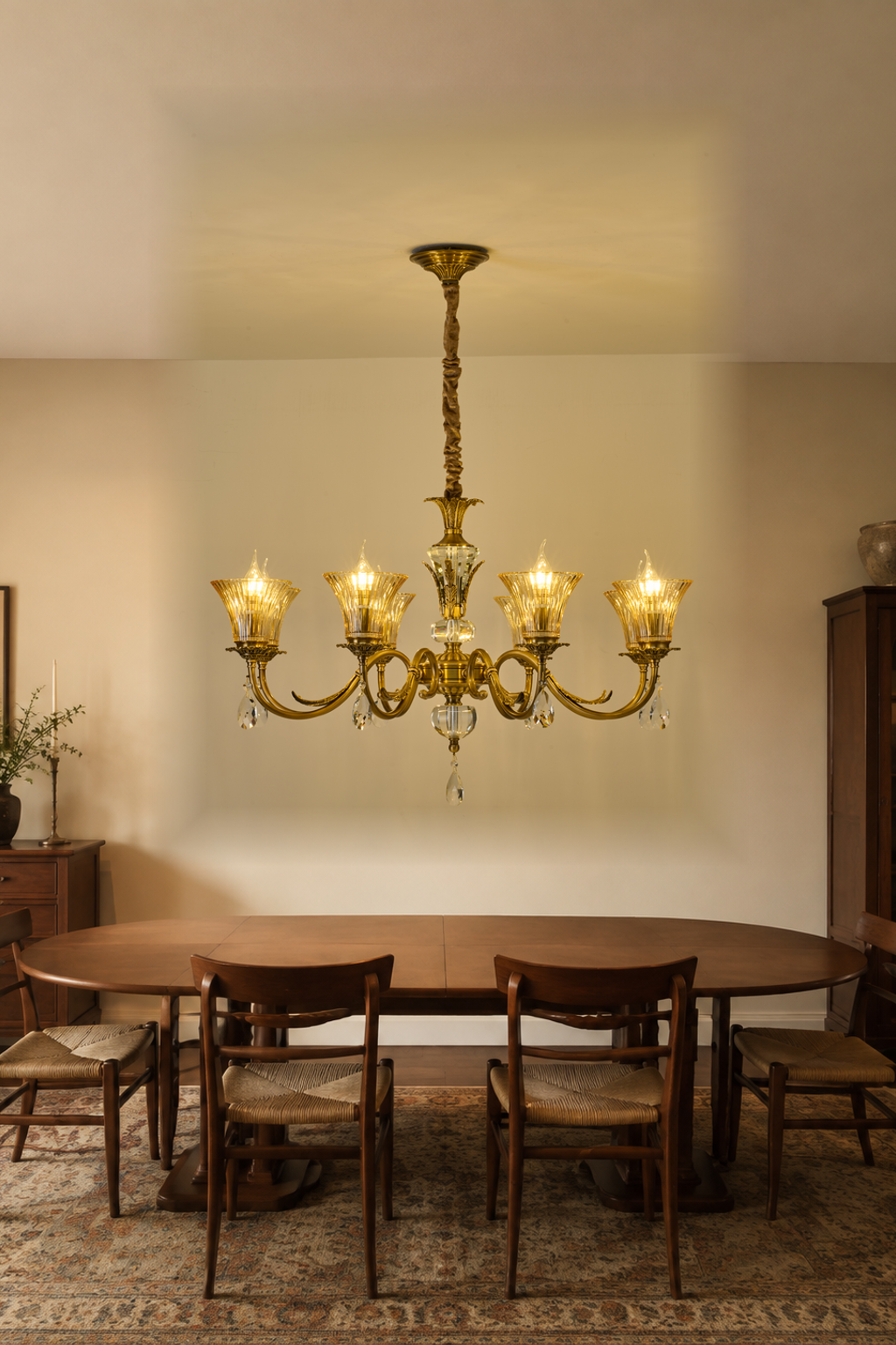 Verelisse eight-light champagne fluted glass chandelier centered above a walnut dining table