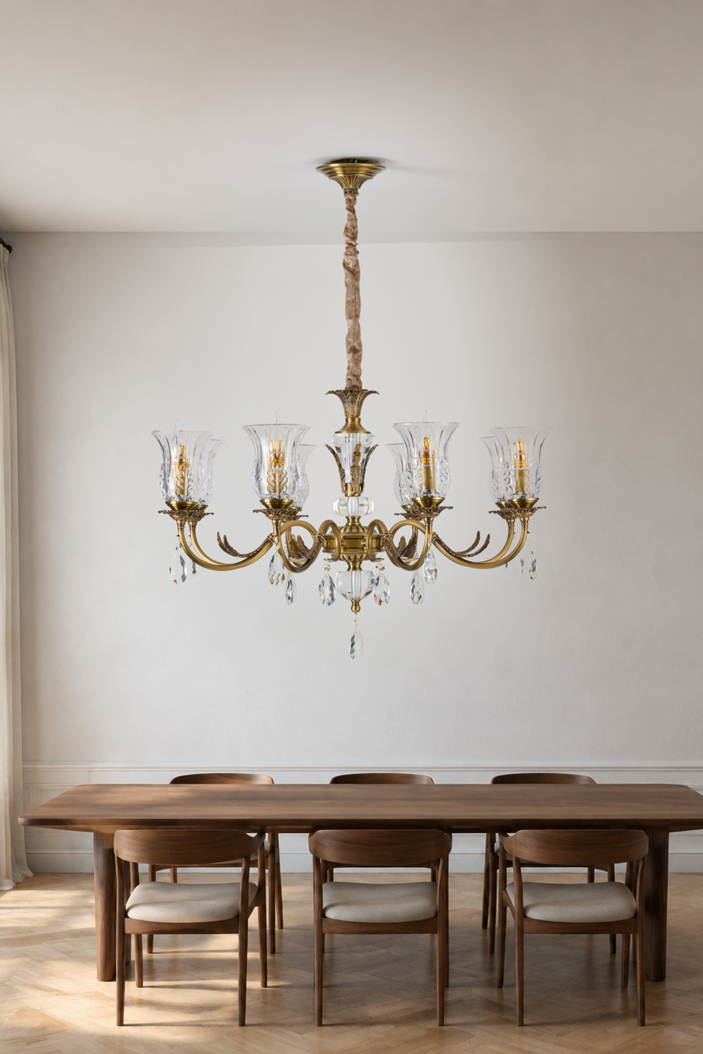 Vitrelaine eight-light clear hurricane glass chandelier centered above a dining table