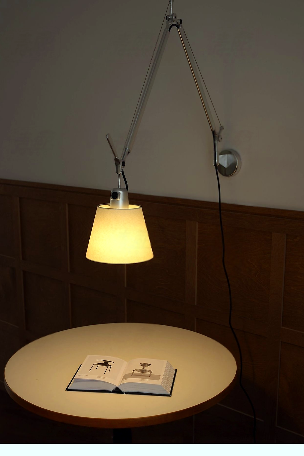 Bauhaus Adjustable Parchment Swing Arm Wall Light over a warm reading table