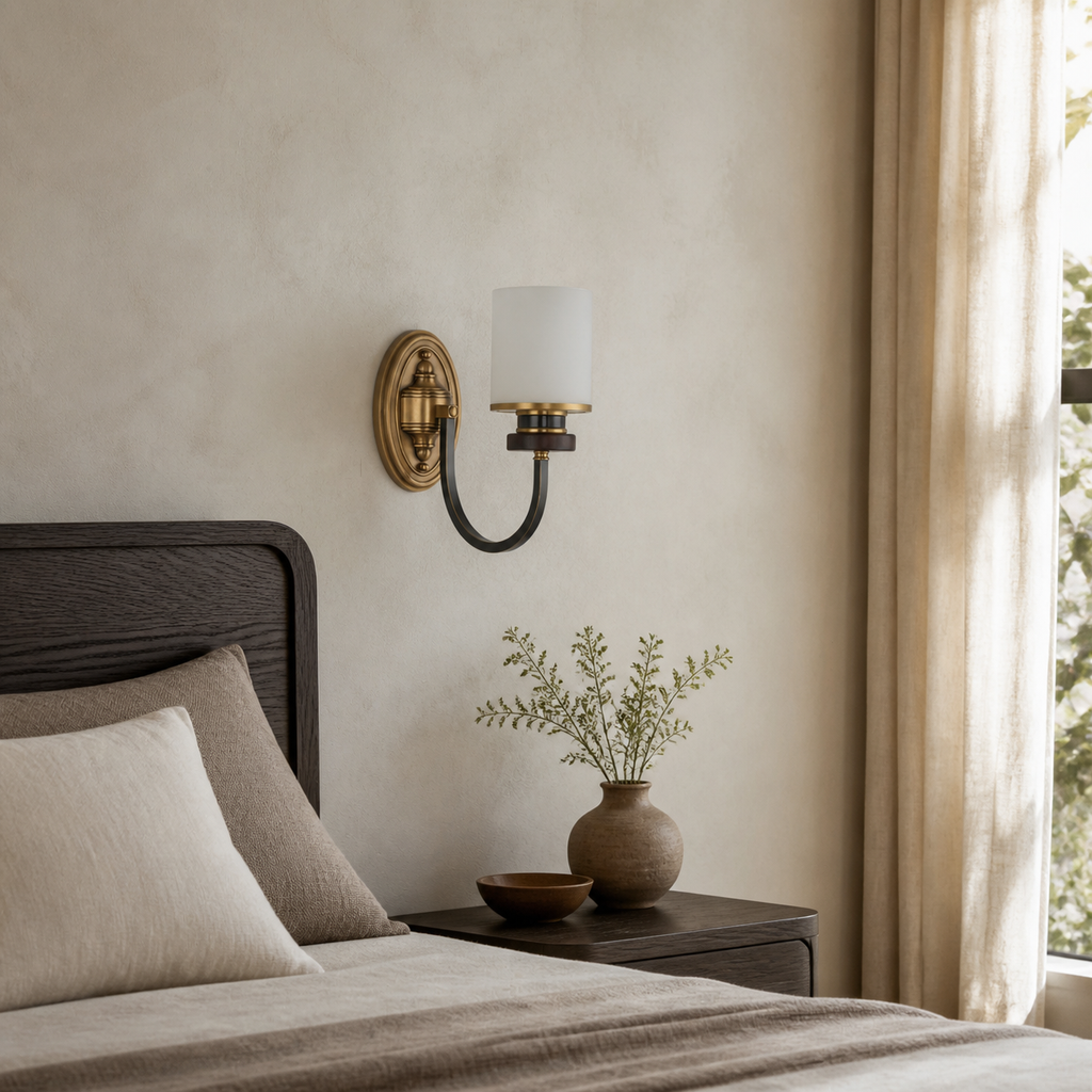 Unlit Ashbourne wall sconce slightly off center beside a dark oak bed with its backplate flush to the wall