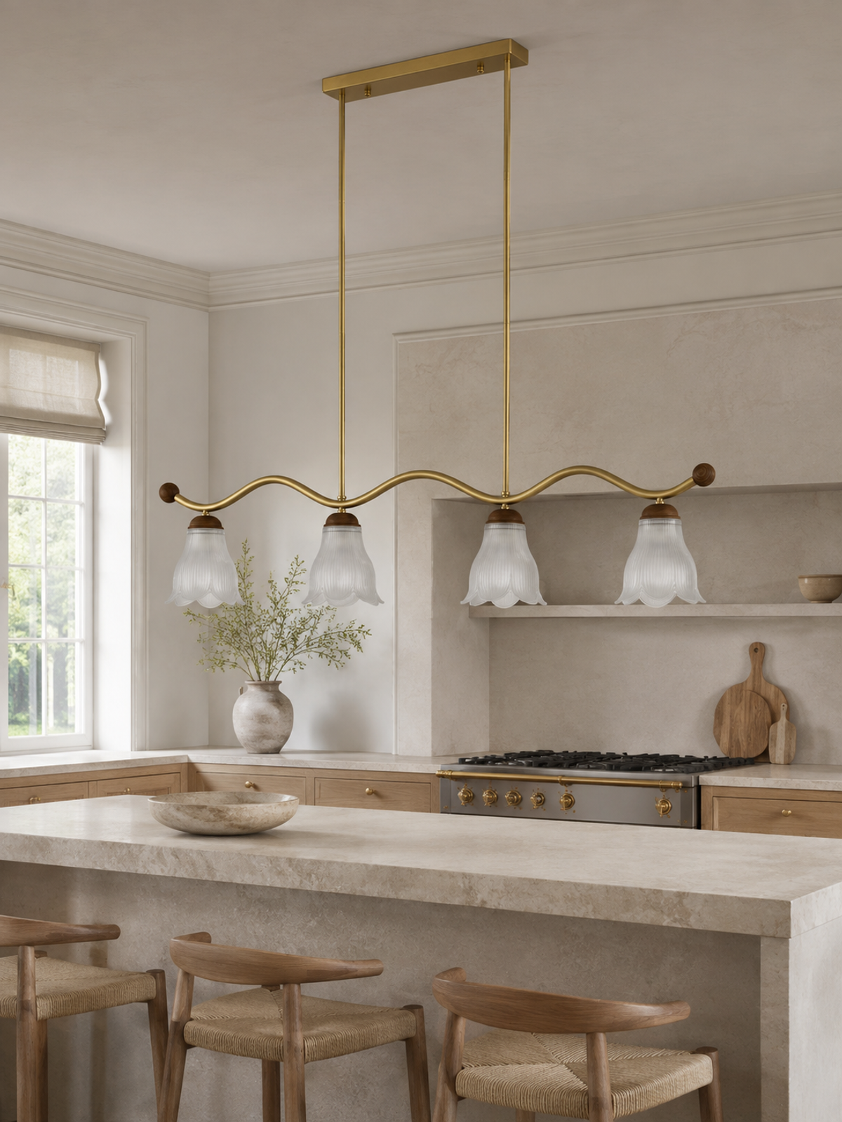 Unlit Cloveraine four-light linear chandelier above a light stone kitchen island