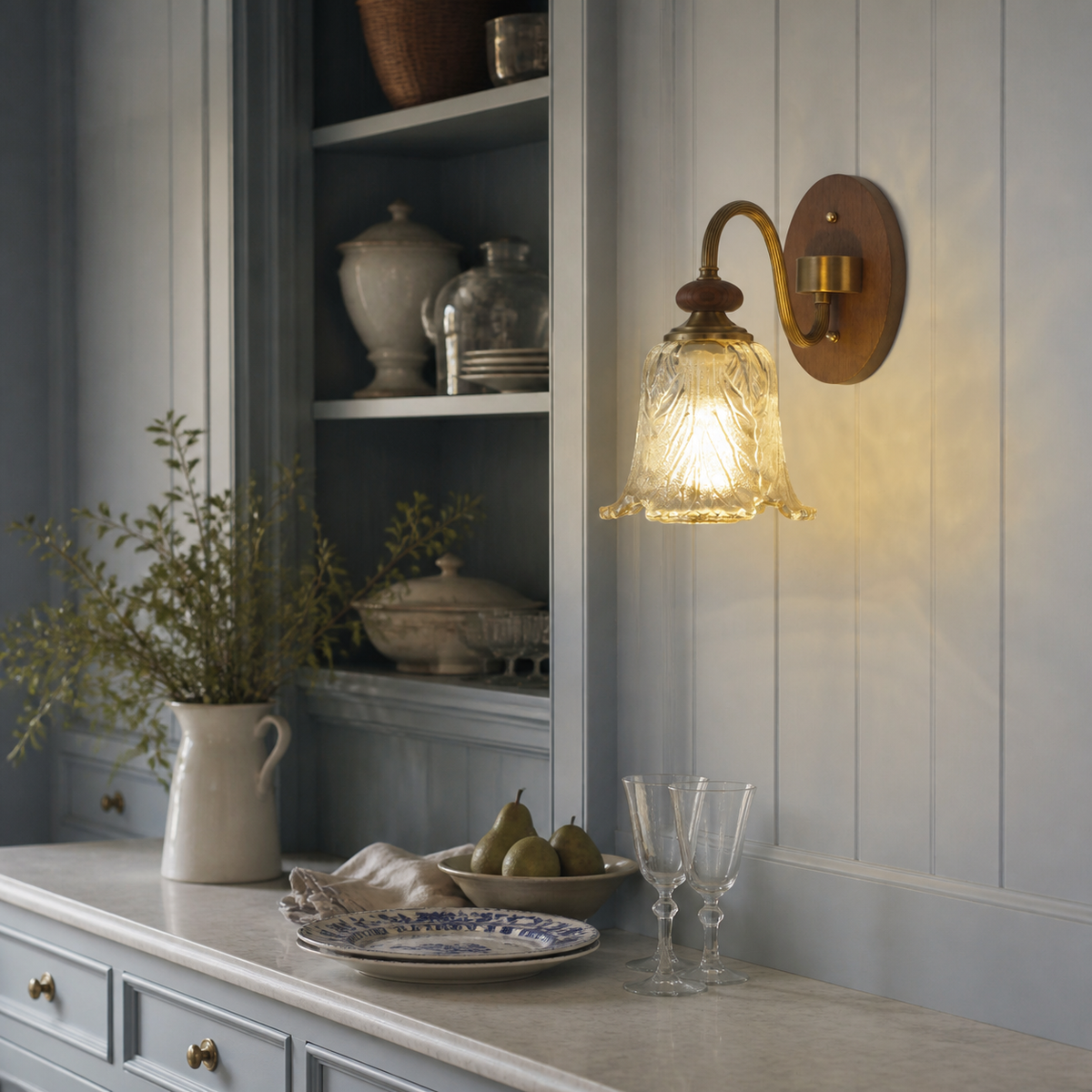 Sculpted leaf glass wall sconce on the right third in a powder-blue serving pantry