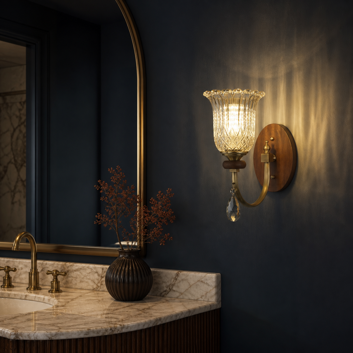 Ribbed tulip glass wall sconce on the right in a dry ink-blue vanity setting