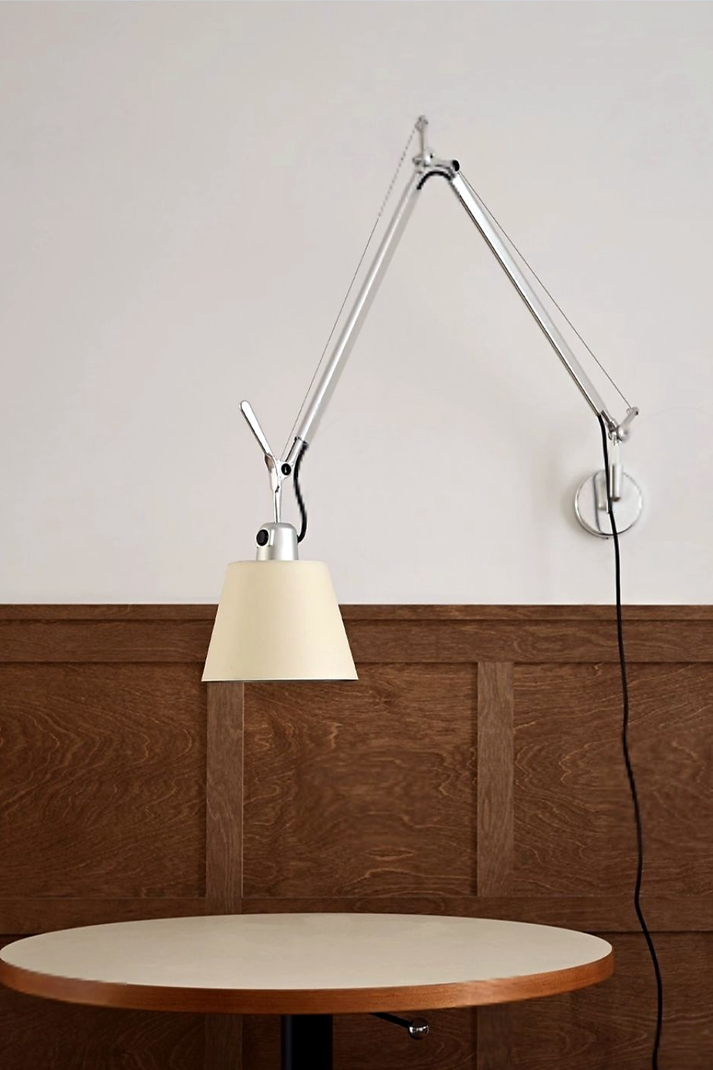 Bauhaus Adjustable Parchment Swing Arm Wall Light in a daylight cafe interior