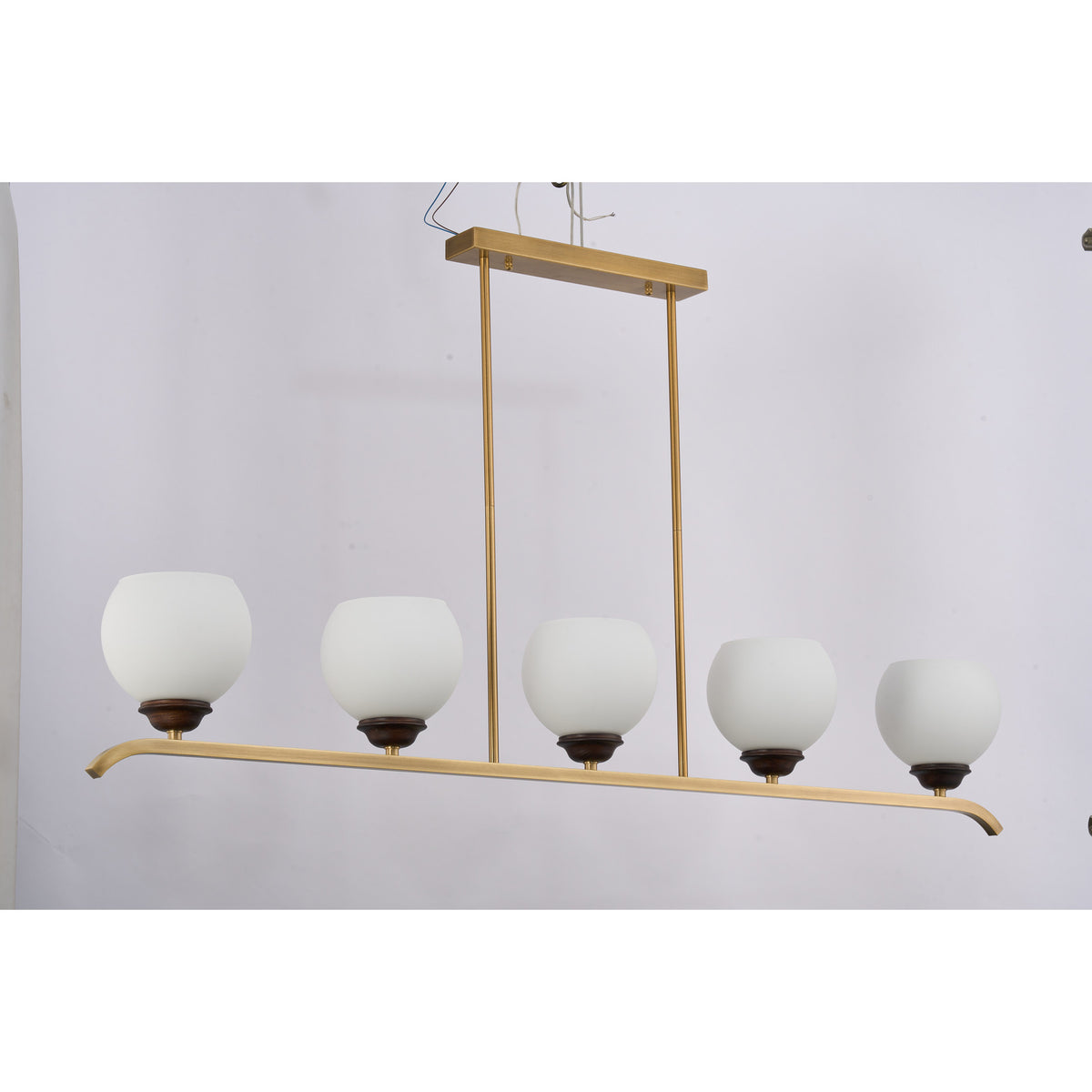 Supplier real photograph of the Avelune five-light linear chandelier complete front view illuminated