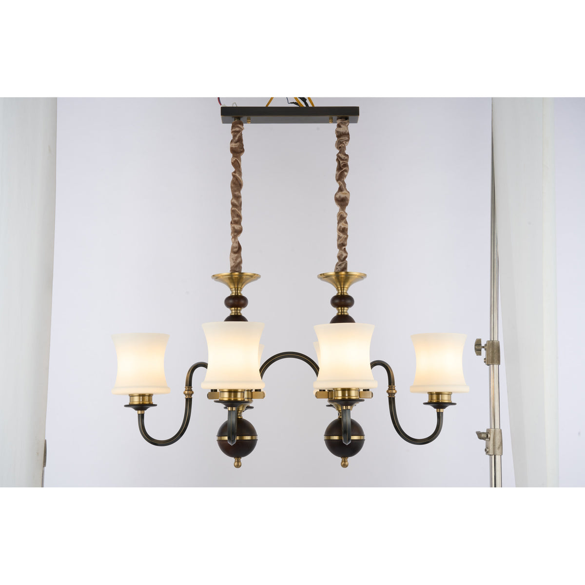 Supplier real photograph of the illuminated Ebonelle six-light linear chandelier complete front view