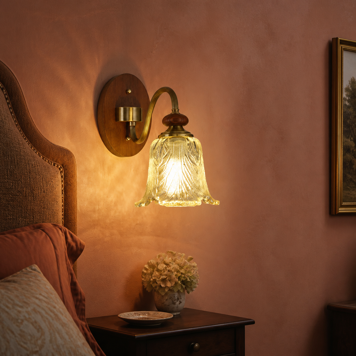 Sculpted leaf glass wall sconce on the left third in a rust-coral bedroom