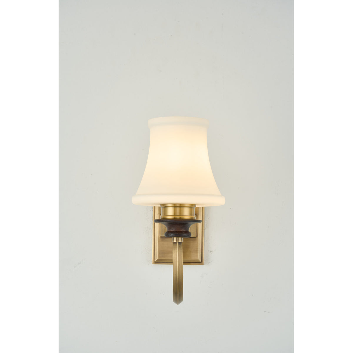 Supplier real photograph of the Kingswell one-light wall sconce complete softly lit front view
