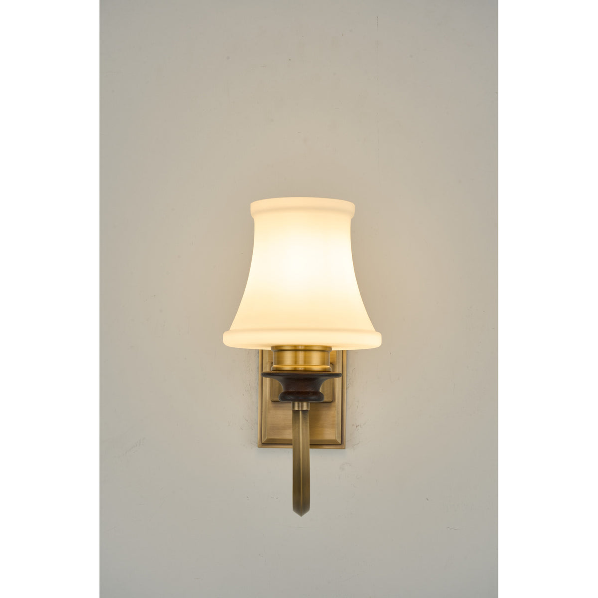 Supplier real photograph of the Kingswell one-light wall sconce complete illuminated front view