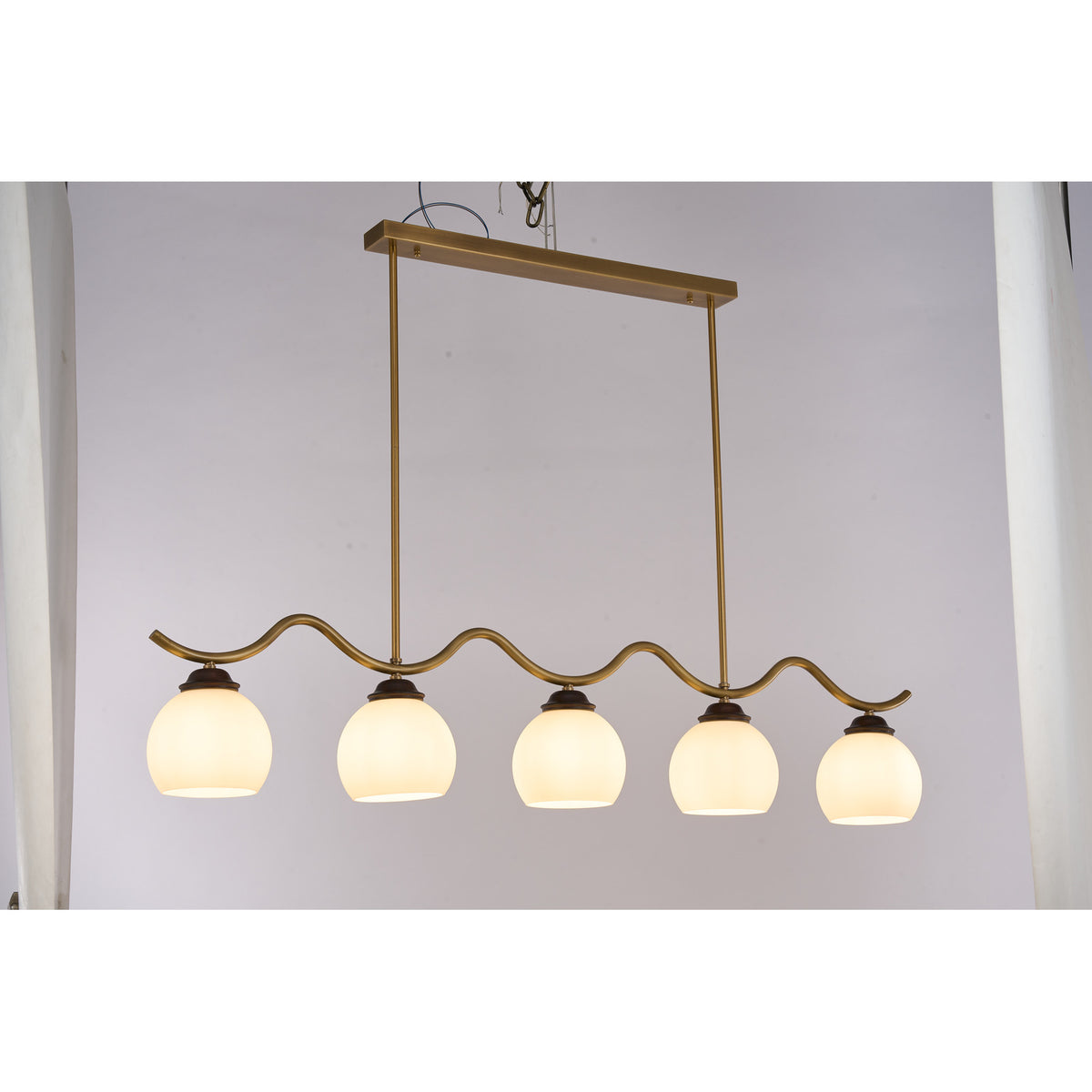 Supplier real photograph of the Ondervale five-light linear chandelier complete lit front view