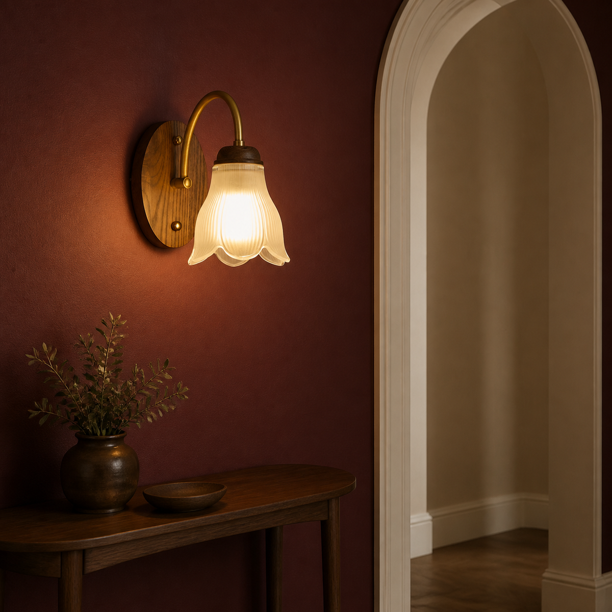 Ribbed bell glass wall sconce on the left in an oxblood hall