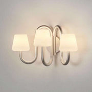 Apollo three-light wall sconce illuminated in the supplier product photograph