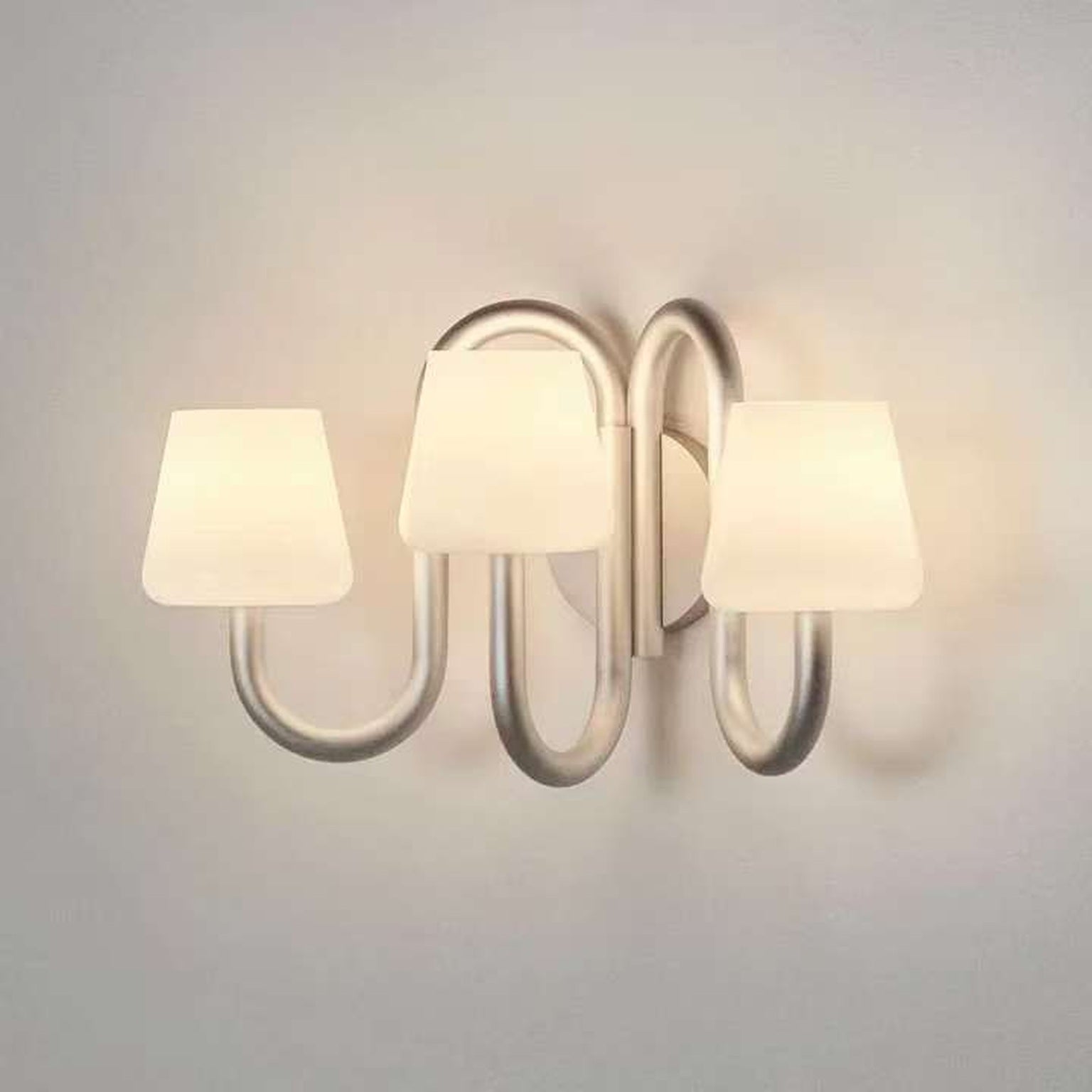 Apollo three-light wall sconce illuminated in the supplier product photograph