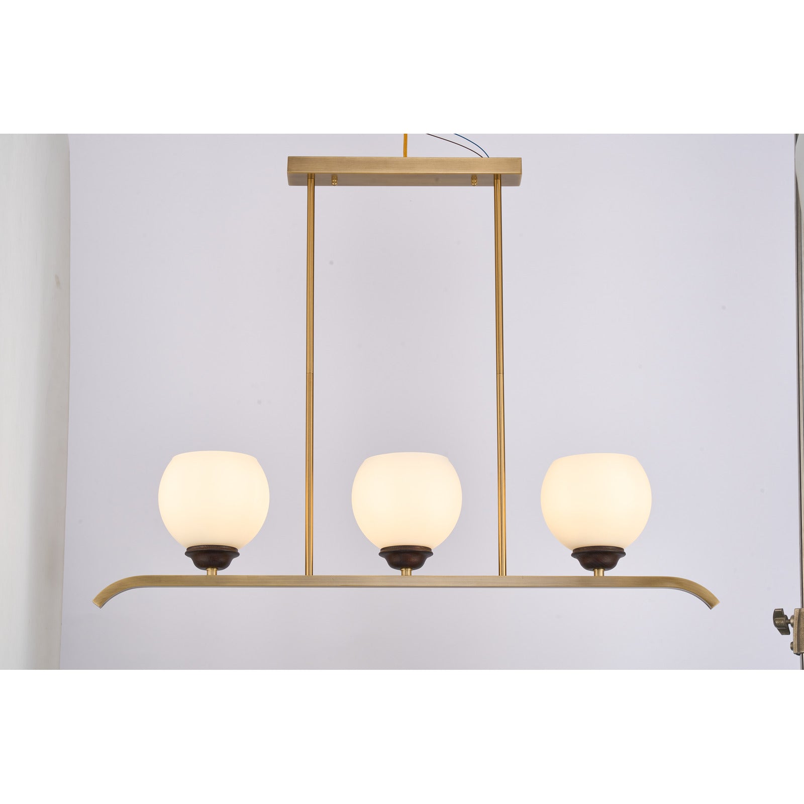 Supplier real photograph of the Avelune three-light linear chandelier complete front view illuminated