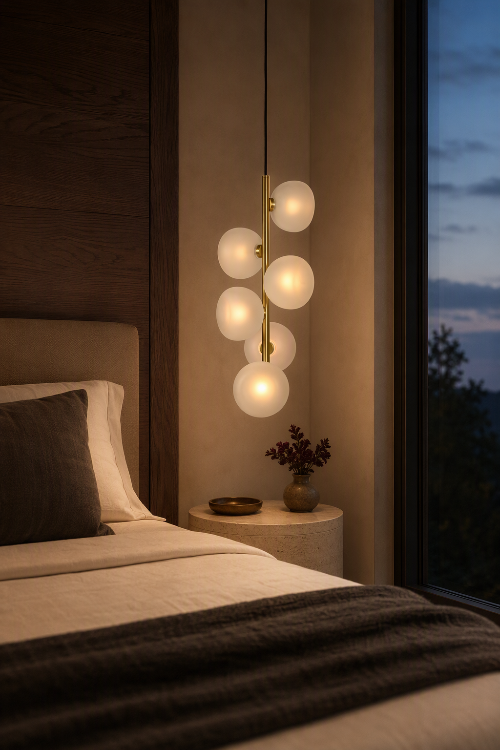 Frosted glass six-light vertical pendant illuminated beside a modern bed