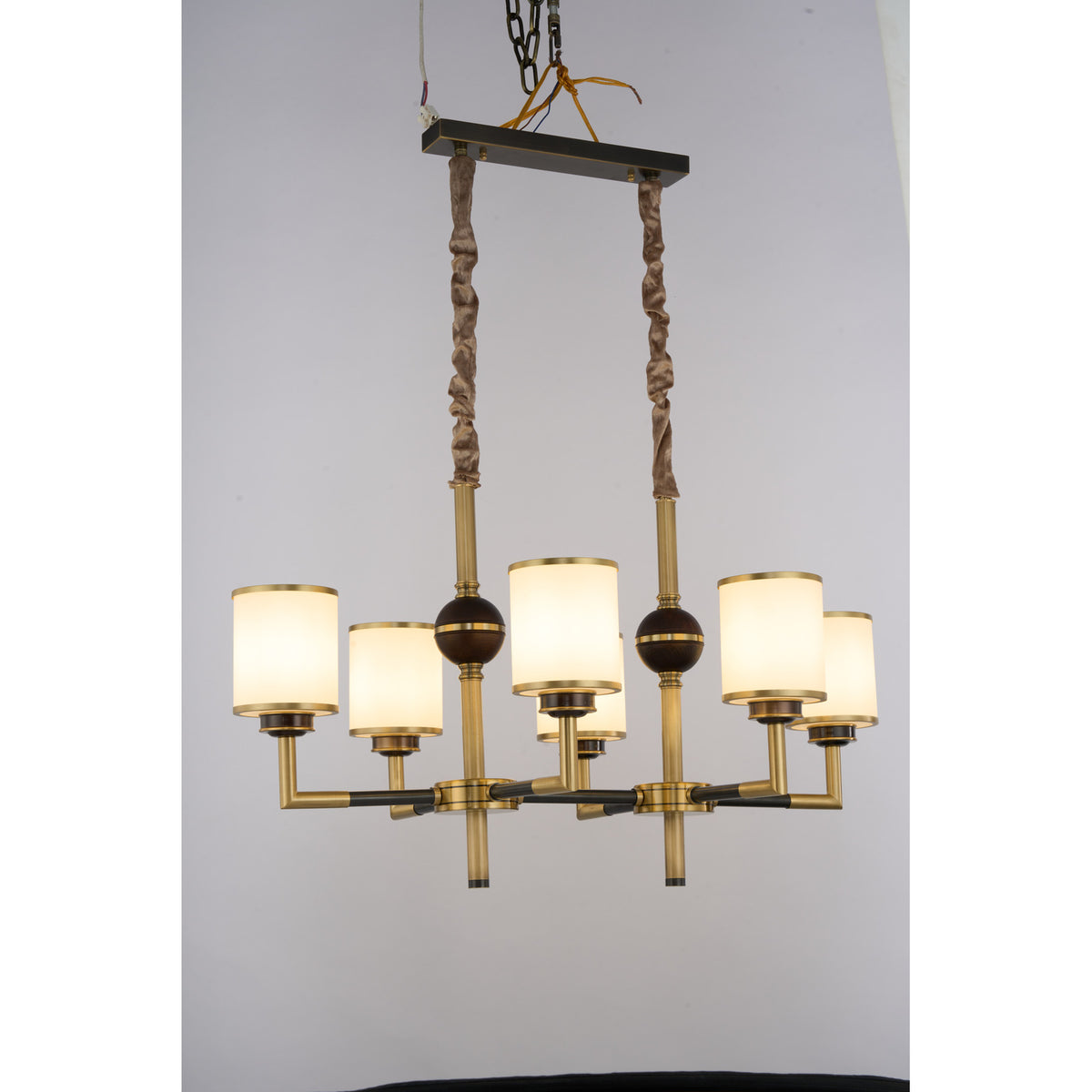 Supplier real photograph of the Orseline six-light linear chandelier complete angled view illuminated
