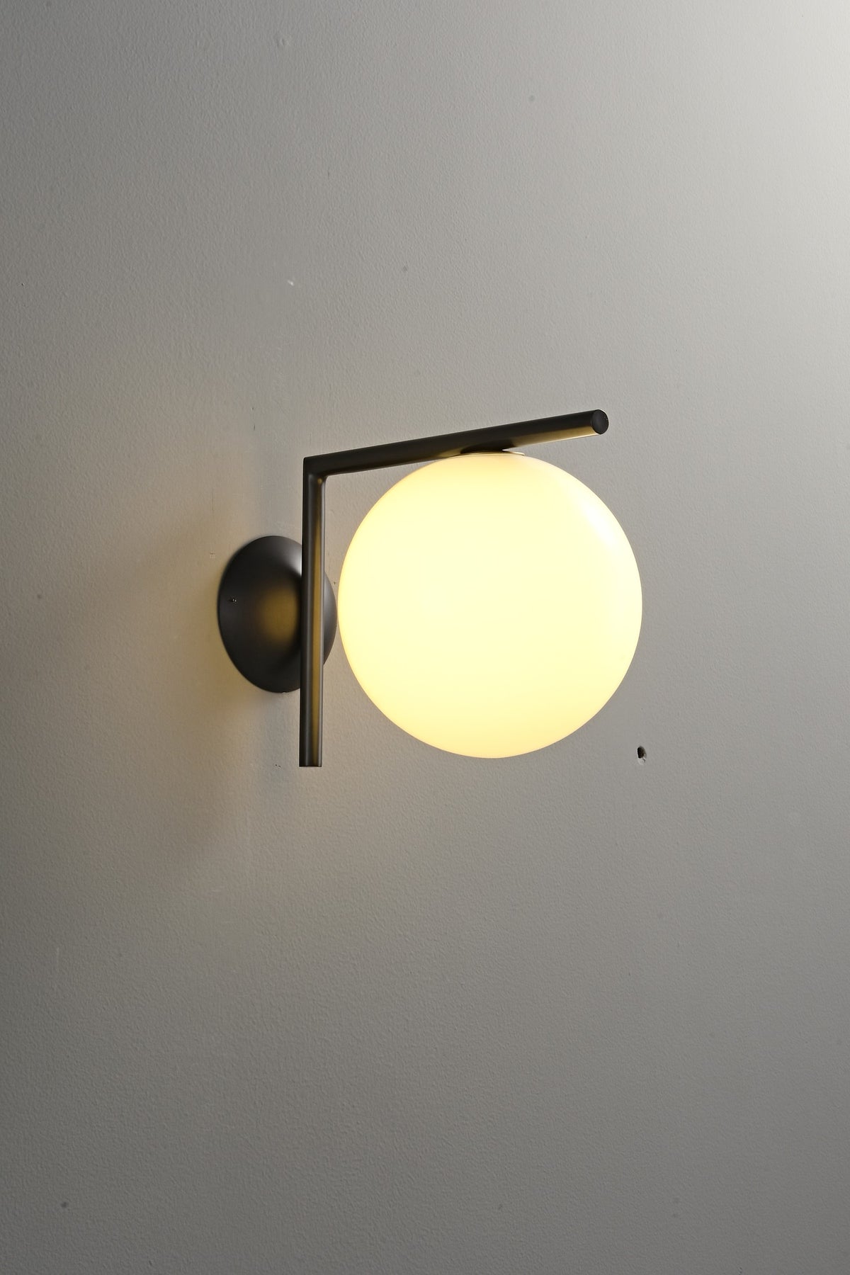 Modern Globe Arm Wall Sconce - 05 05-real-shot-black-globe-arm-wall-sconce-lit