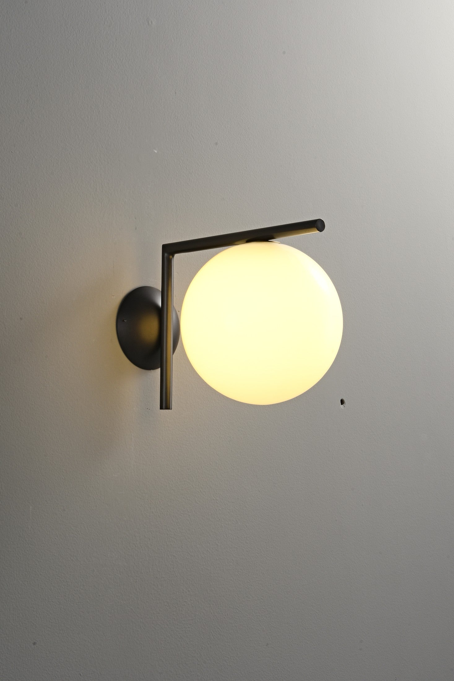 Modern Globe Arm Wall Sconce - 05 05-real-shot-black-globe-arm-wall-sconce-lit