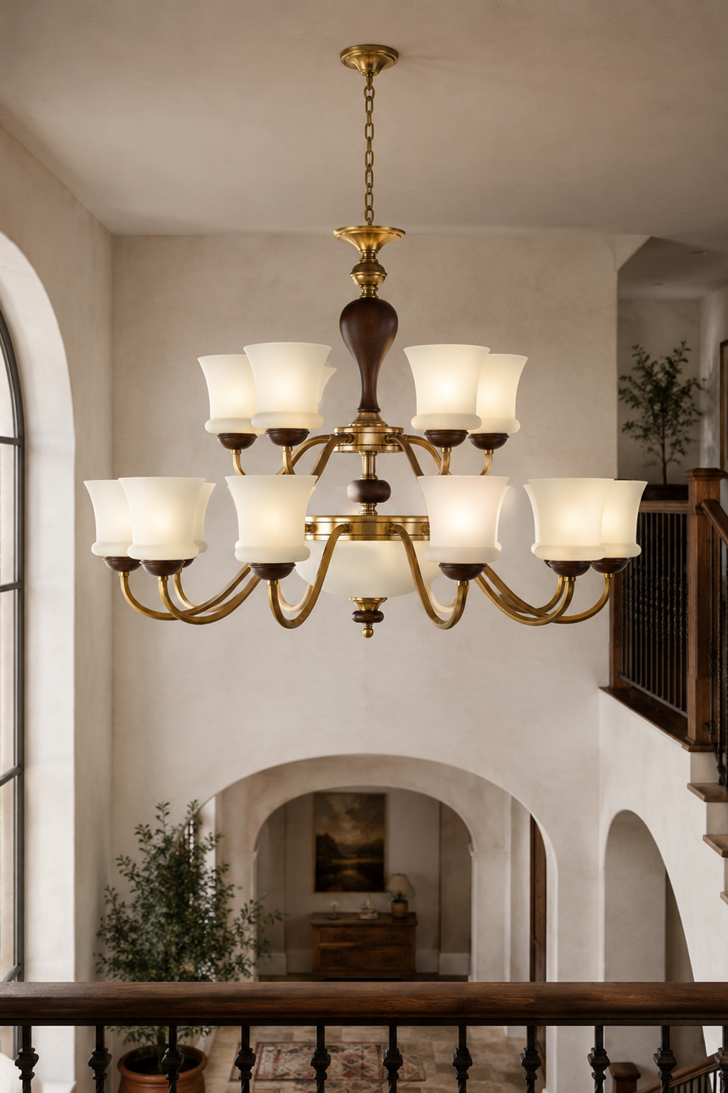 Halveraine fifteen-light two-tier chandelier centered in a double-height stair hall, fixture lit