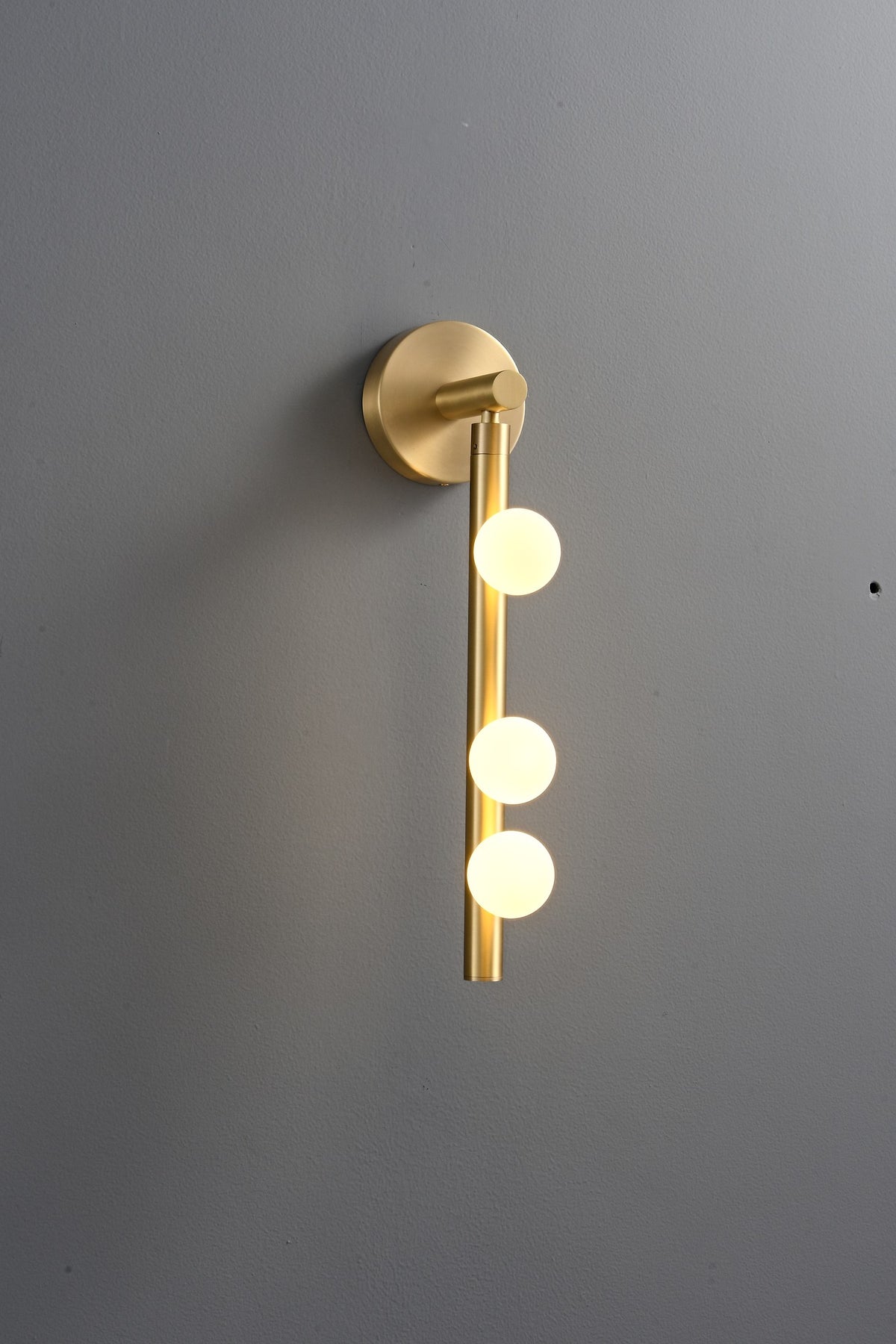 Modern Glass Globe Vertical Wall Sconce - 06 06-real-shot-brass-globe-vertical-wall-sconce-lit