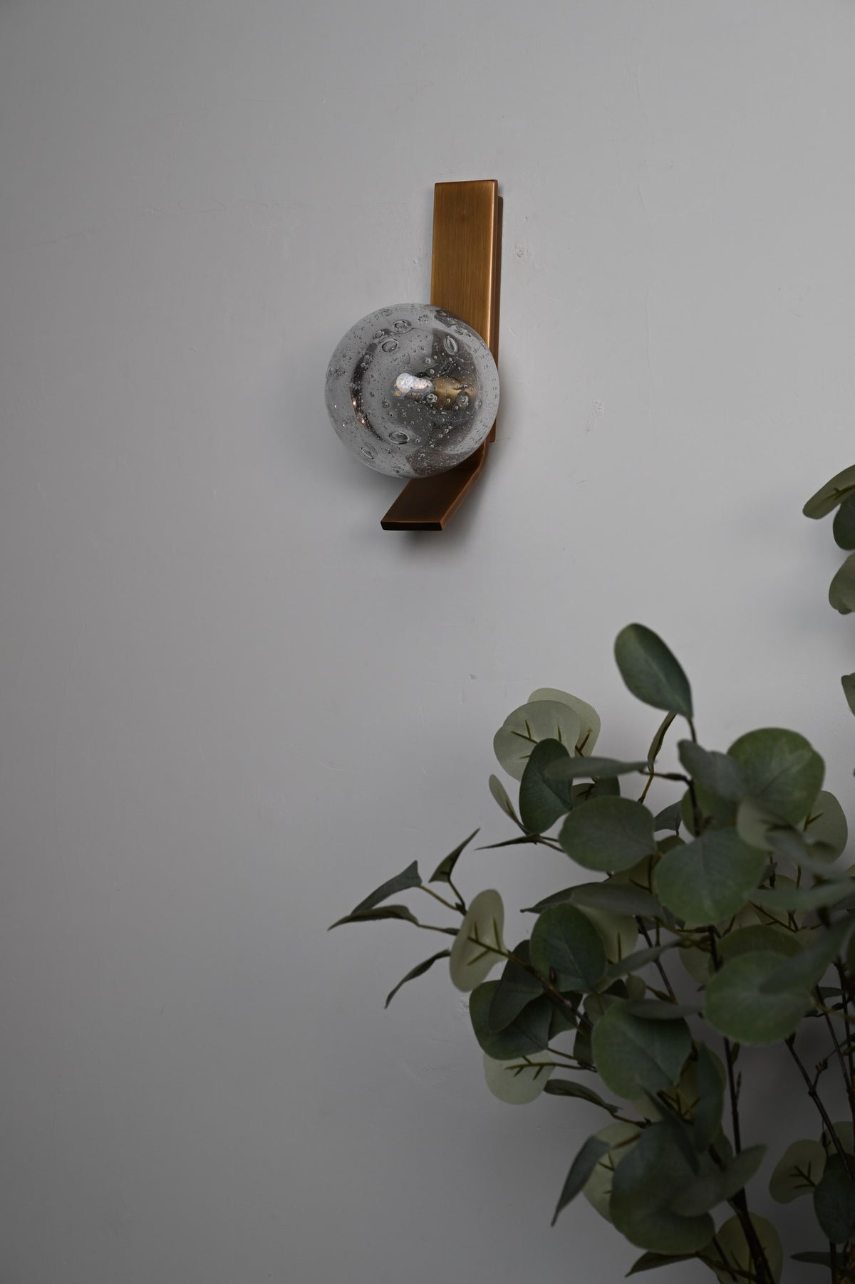 Modern Glass Globe Wall Sconce in Antique Brass - 06 06-real-shot-glass-globe-wall-sconce-lit-detail