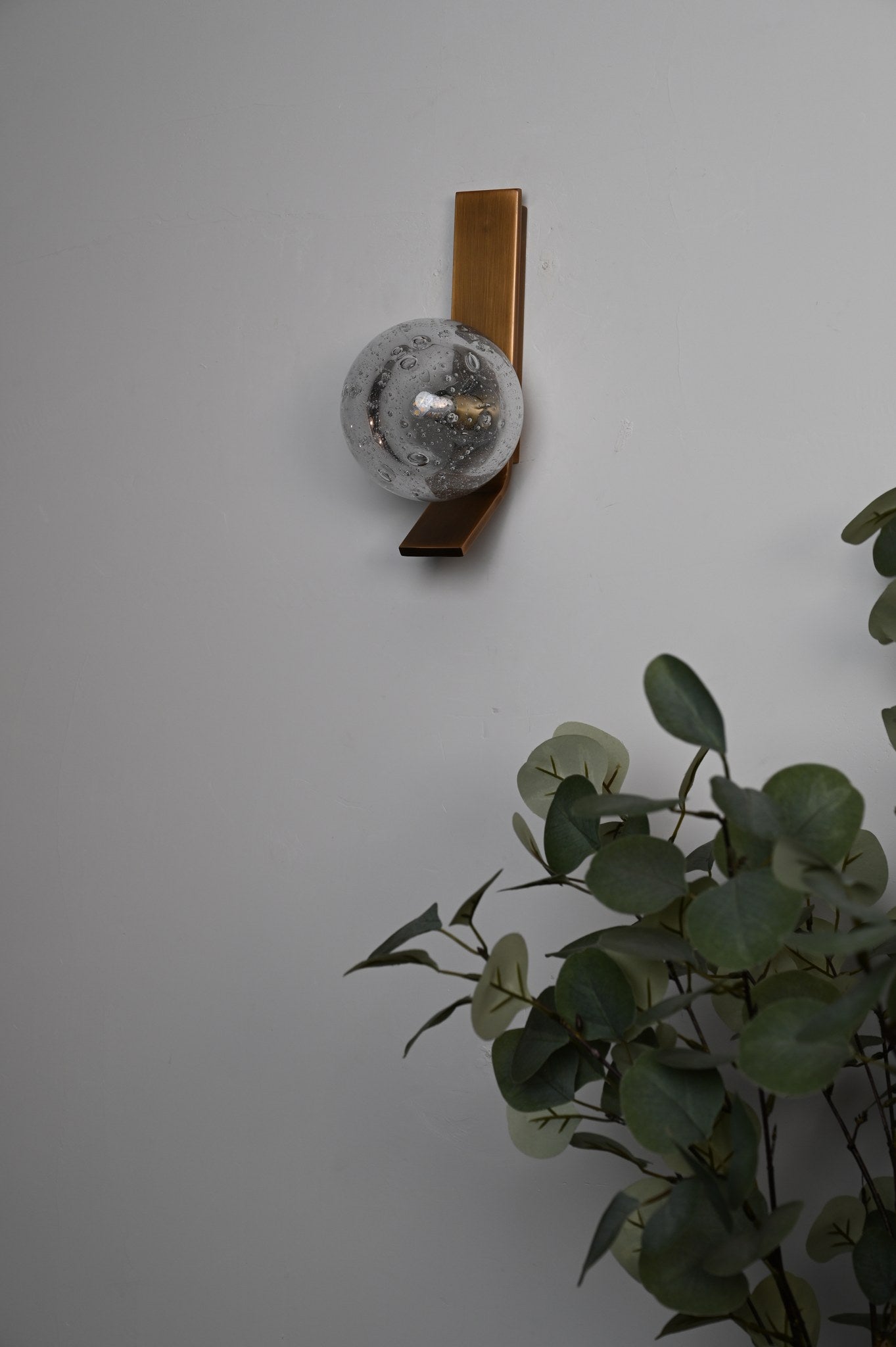 Modern Glass Globe Wall Sconce in Antique Brass - 06 06-real-shot-glass-globe-wall-sconce-lit-detail
