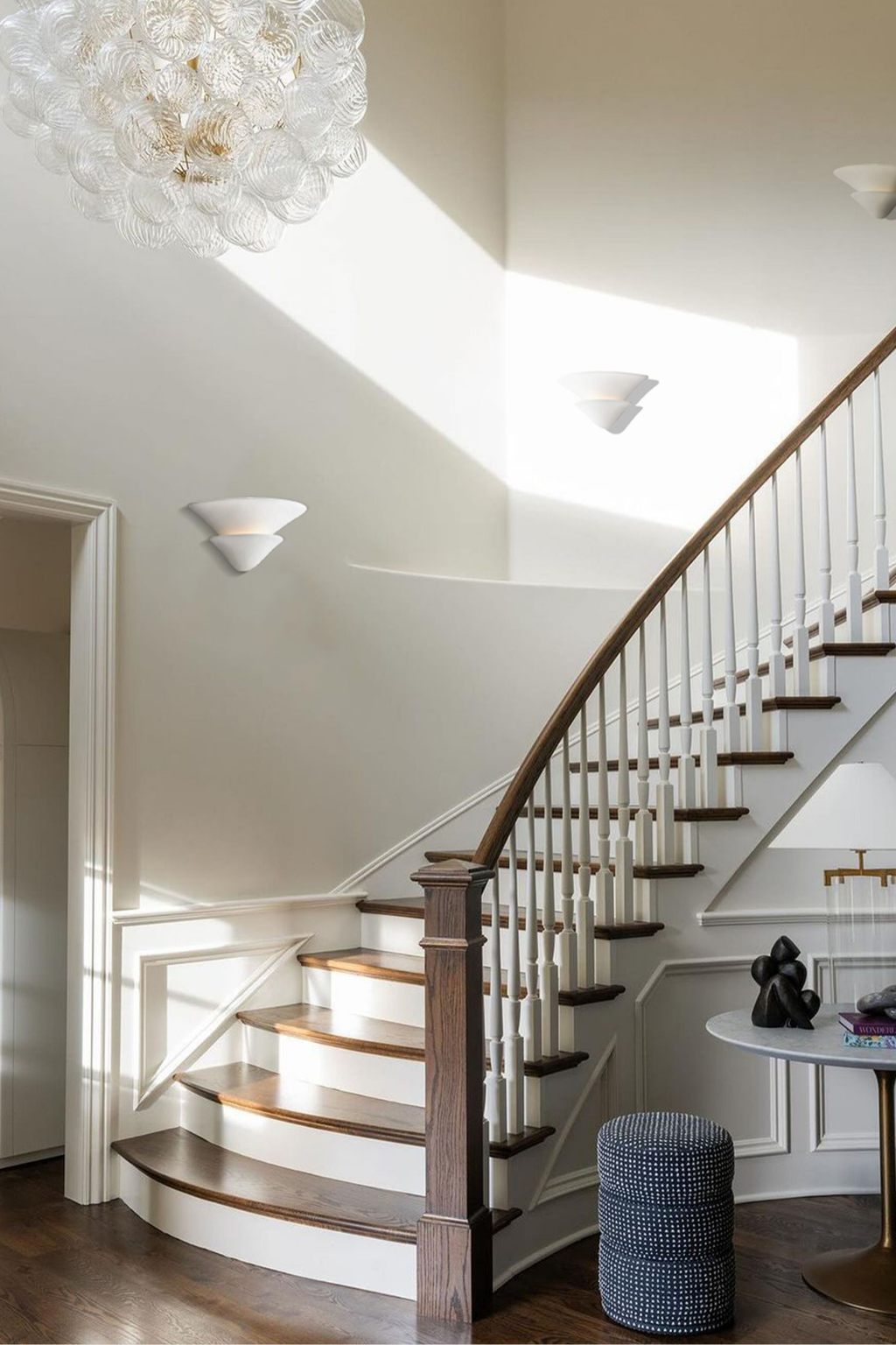 Sculptural Double-Tier Plaster Wall Sconce — complete real wall sconce beside a staircase