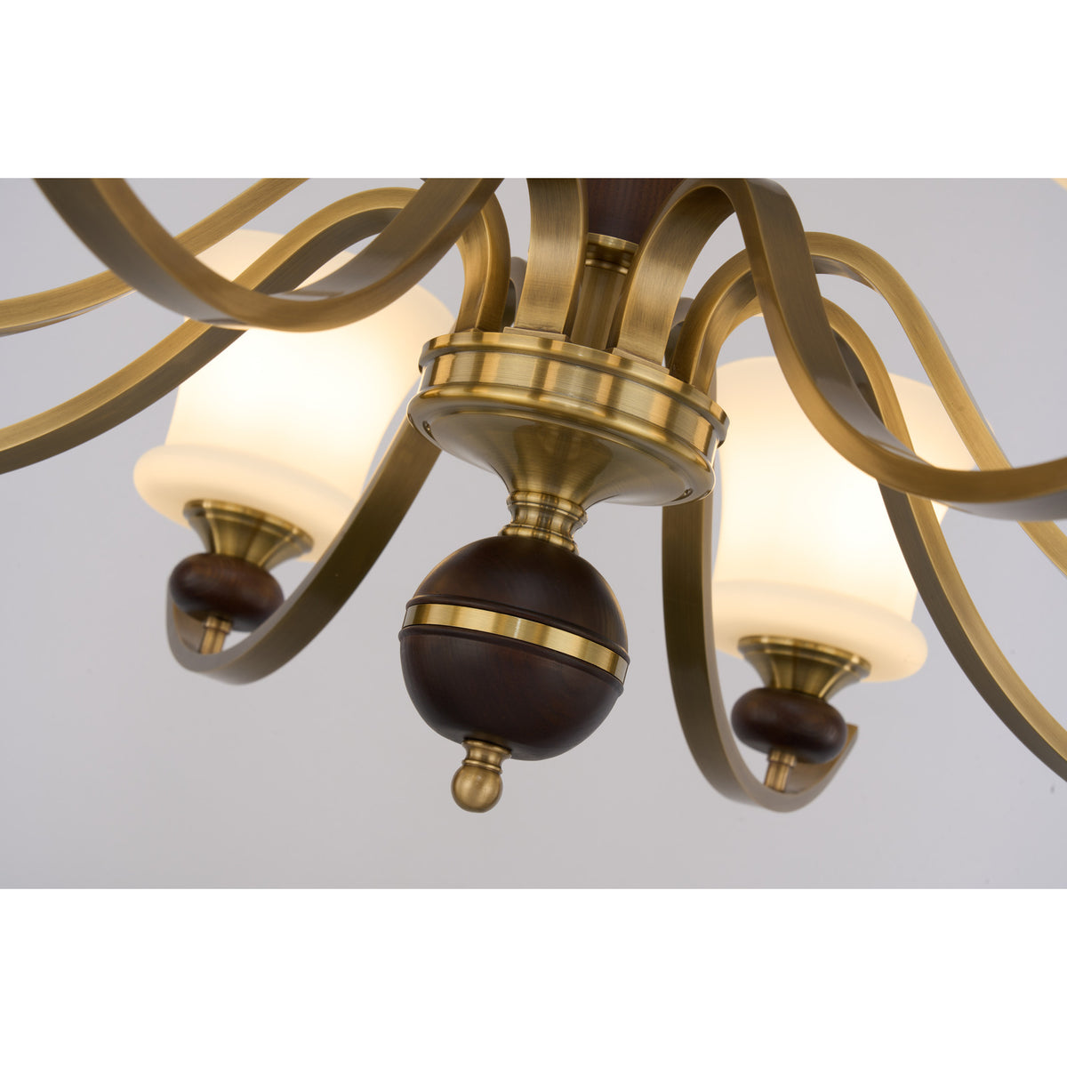 Supplier real detail photograph of the Brontelle dark ash-wood finial and antique brass center hub