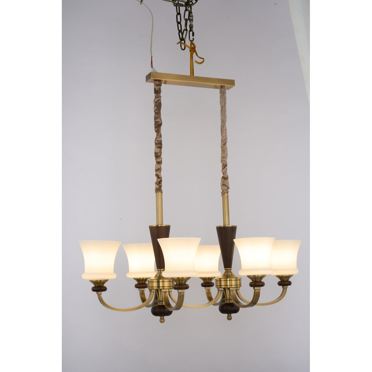 Caldrienne six-light linear chandelier three-quarter lit real product view