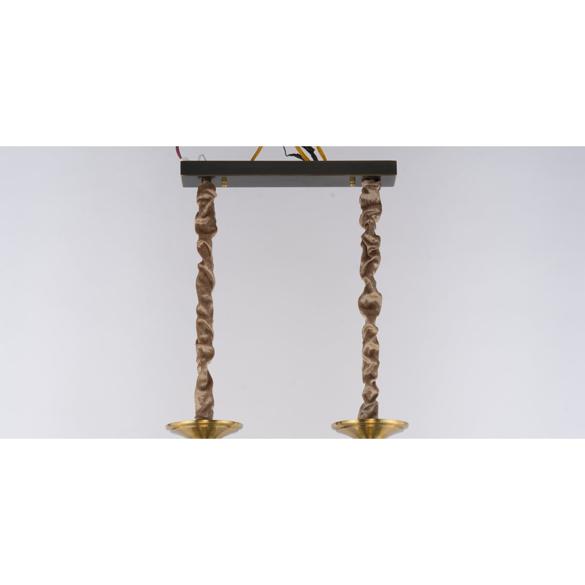 Supplier real detail crop of the Ebonelle linear canopy and twin fabric-wrapped suspensions