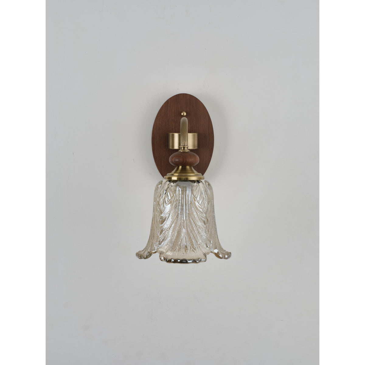 Real front product photograph of the sculpted leaf glass wall sconce