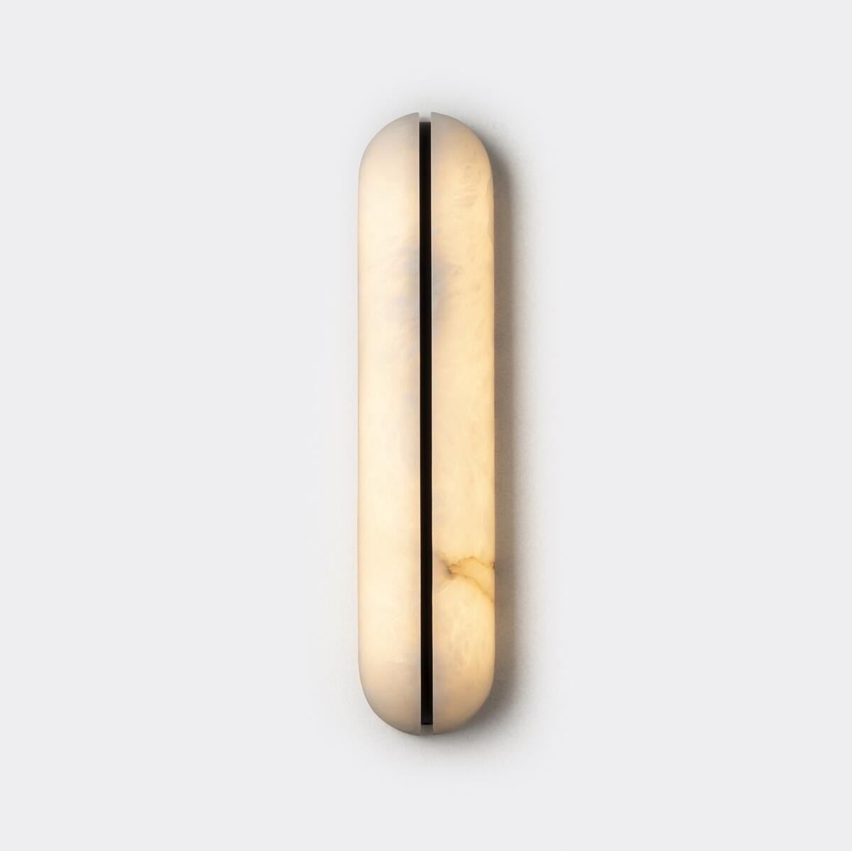 Real small alabaster capsule wall sconce front view