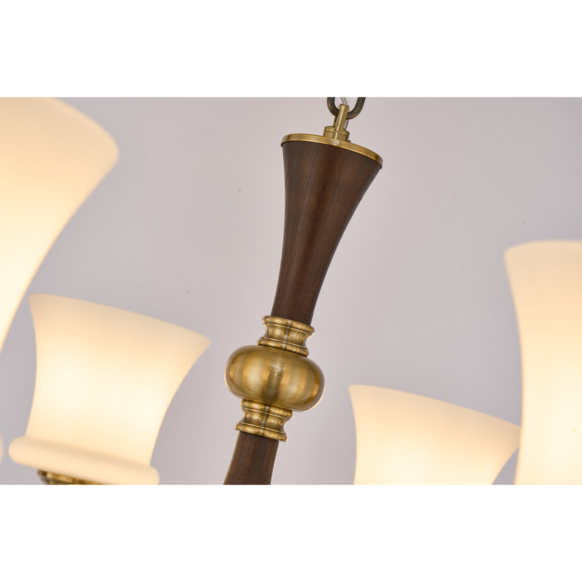 Supplier real detail photograph of the Rosethorne tapered dark ash-wood spindle and antique-brass collar
