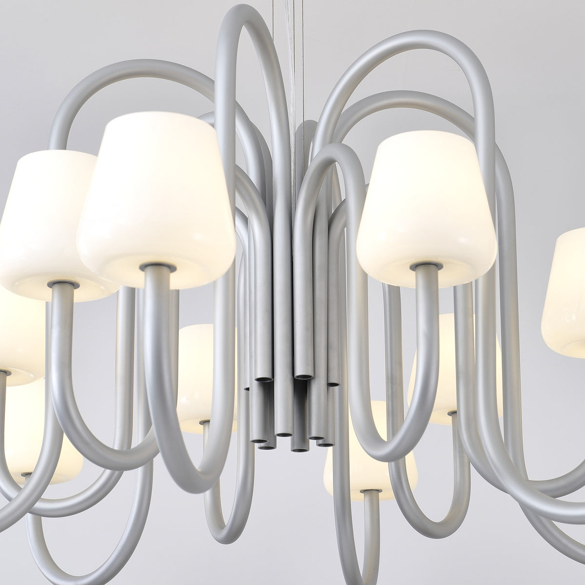 Close supplier photograph of the Apollo chandelier central tubes and looping aluminum arms